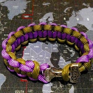 Paracord purple and green bracelet with Thor's Hammer closure.